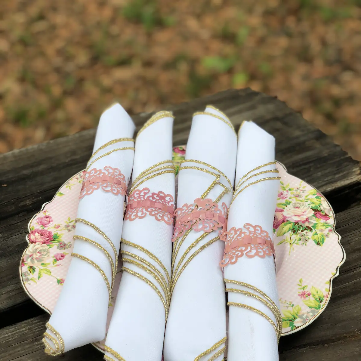 romantic-afternoon-tea-party-theme-The-Tea-Party-Company 4 white napkins folded on top of a shabby chic dinner plate
