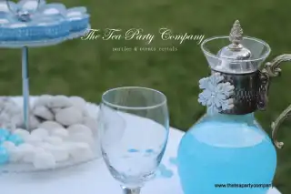 clear goblet glass with a clear glass carafe filled with blue liquid