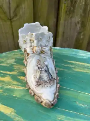 Ornate porcelain victorian boot depicting a couple