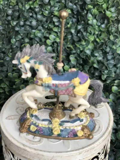multicolor carousel horse with flowers on base