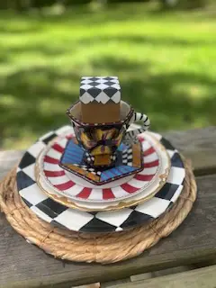 tea party rentals | The Tea Party Company round natural fibers charger alice in womnderland motif teacup saucer and dinner plate