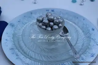 clear glass teacup and saucer with silver christmas glitter balls