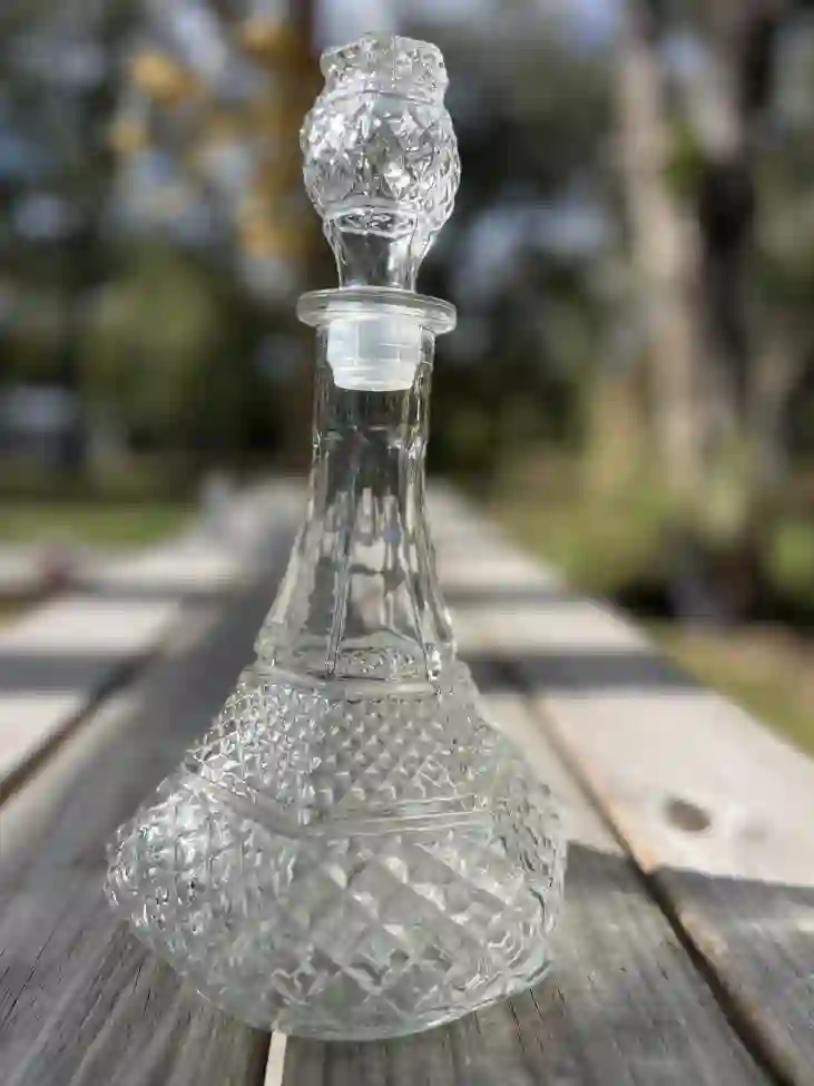 clear glass liquor bottle