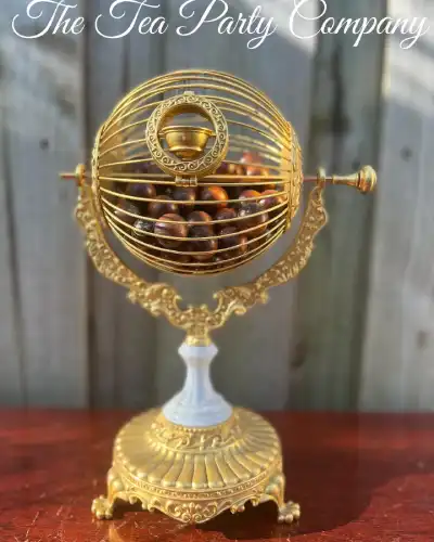 bridgerton & downton abby theme party | The Tea Party Company gold sphere bingo cage white pedestal