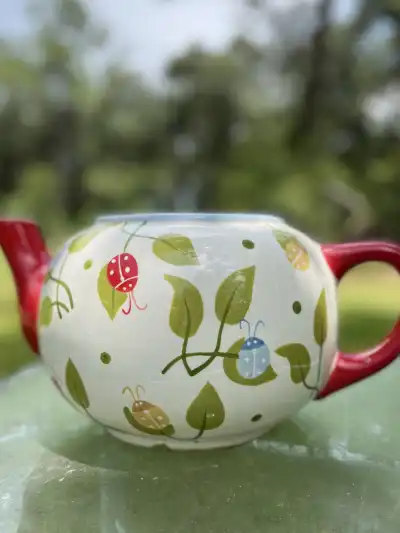 alice in wonderland theme party | The Tea Party Company Ceramic teapot planter with red spout and handler with green leafs design.