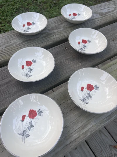 matching china rentals | The Tea Party Company 6 cream with a red rose vintage bowls sitting on a table.