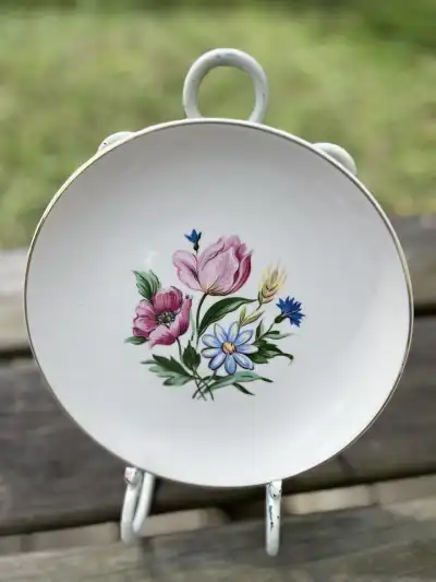 salad plates rentals | The Tea Party Company Vintage salad plate cream color with a floral arrangement in the center and a gold rim.