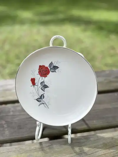 salad plates rentals | The Tea Party Company Beautiful Salad Plate Cream Color with a very vivid red rose on the edge.