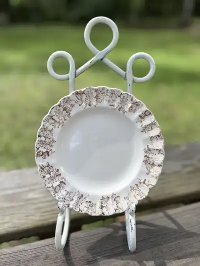 salad plates rentals | The Tea Party Company Cream colr plate with gold filigree on edge.