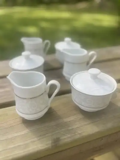 matching china rentals | The Tea Party Company 3 milk and 3 sugar bowls placed on a wood base.