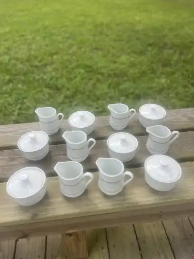 matching china rentals | The Tea Party Company 6 milk and 6 sugar bowls standing on a wood surface> White with silver details
