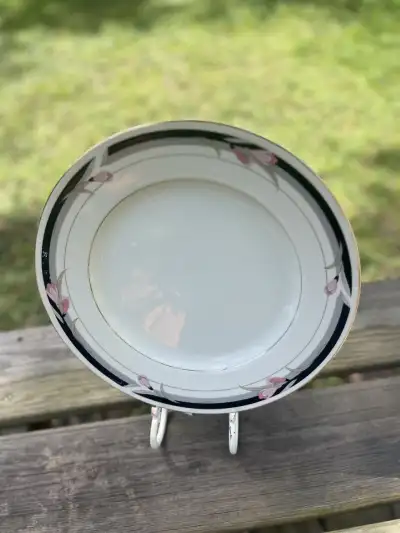 mismatch china rentals | The Tea Party Company Basic charger plate with black design on the edge and some branches wittyh pink color