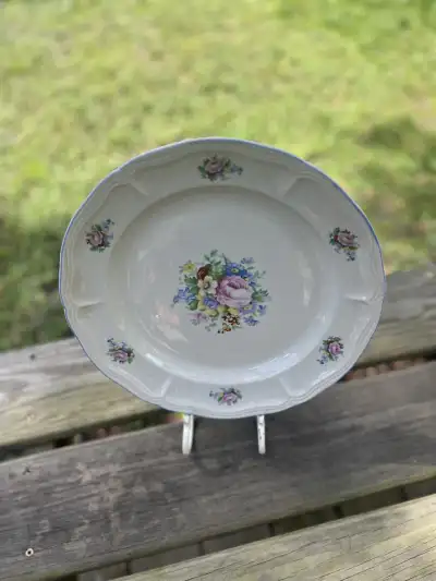 mismatch china rentals | The Tea Party Company Charger plate made of ceramic off white color with a bunch of flowers in the center and also flowers on the brim.
