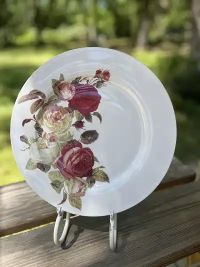 dinner plates rentals | The Tea Party Company modern dinner plate with some roses red and yellow on the side