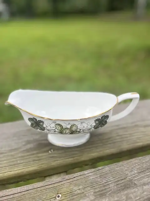 mismatch china rentals | The Tea Party Company Gravy bowl decorated with a hop vine pattern in shades of green, yellow, and white.