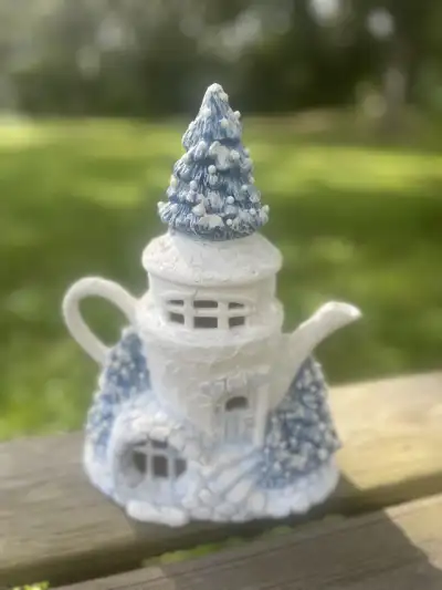 mismatch tea pots rentals | The Tea Party Company Tall white and blue christmas teapot with a tree on the lid