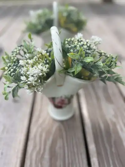 Porcelain cream vase with flower arrangement.
