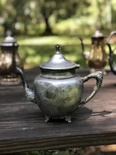 silver plated rentals | The Tea Party Company Pewter Silverr Tea Pot On Top of a Table.