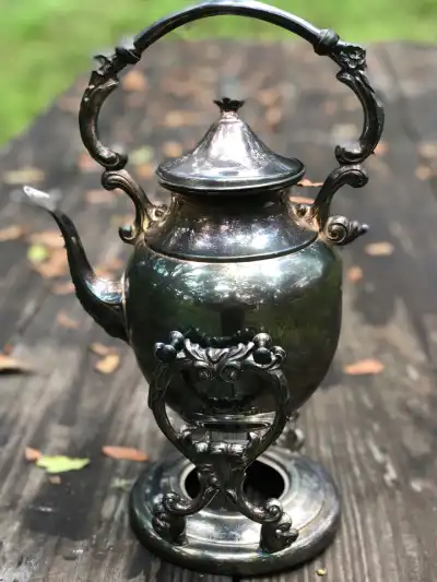 silver plated rentals | The Tea Party Company Silverr Tea Pot Onhanging From a Tilting Base.