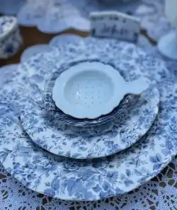 blue teacups and white tea drainer
