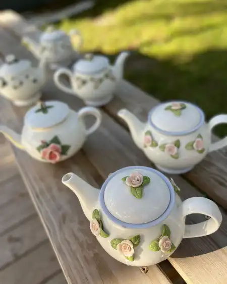 mismatch tea pots rentals | The Tea Party Company vintage teapots with roses