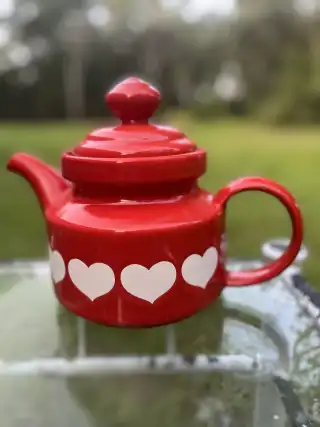 mismatch tea pots rentals | The Tea Party Company red teapot with white hearts san valentine