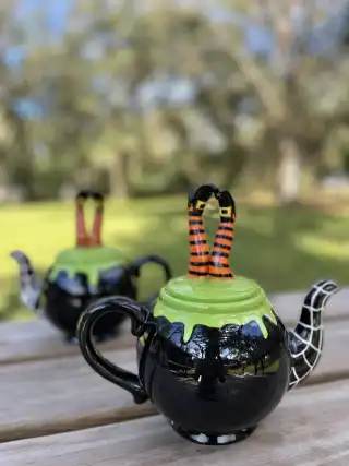 mismatch tea pots rentals | The Tea Party Company black halloween teapot witch legs lid