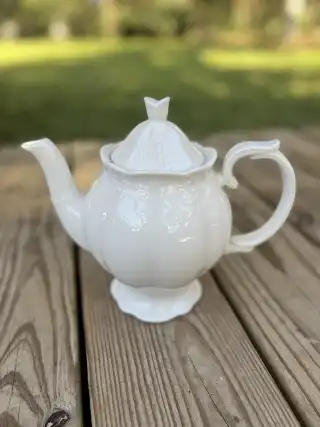 mismatch tea pots rentals | The Tea Party Company white teapot butterfly finnial lid